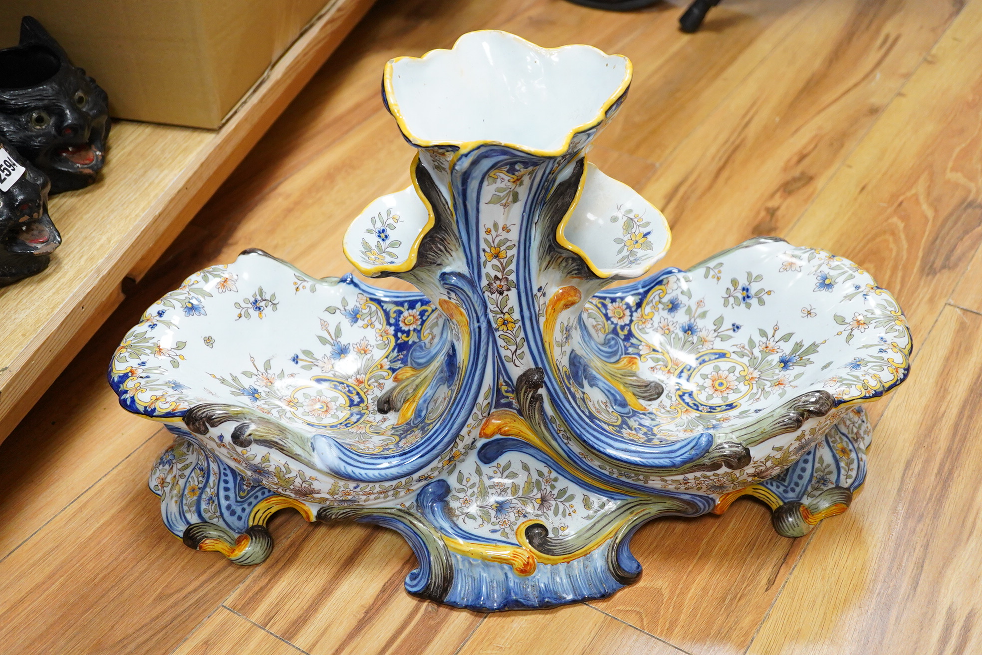 A large decorative French faience shell shaped centrepiece with central vase sections for flowers, 33cm high